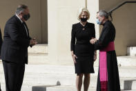 U.S. Secretary of State Mike Pompeo, left, and U.S. Ambassador to the Holy See Callista L. Gingrich greet Monsignor Joseph Murphy, head of Vatican protocol, as they leave after meeting Vatican Secretary of State Cardinal Pietro Parolin, at the Vatican, Thursday, Oct. 1, 2020. Pompeo is meeting Thursday with top Vatican officials, a day after tensions over U.S. opposition to the Vatican's China policy spilled out in public. (AP Photo/Andrew Medichini)