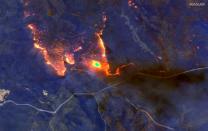 A satellite image shows wildfires burning east of Obrost, Victoria