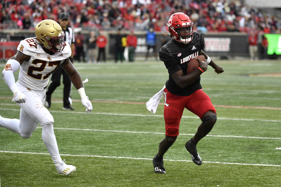 Louisville quarterback Malik Cunningham (3) outruns Boston College linebacker Kam Arnold (27) for a touchdown in the first half of an NCAA college football game in Louisville, Ky., Saturday, Oct. 23, 2021. (AP Photo/Timothy D. Easley)