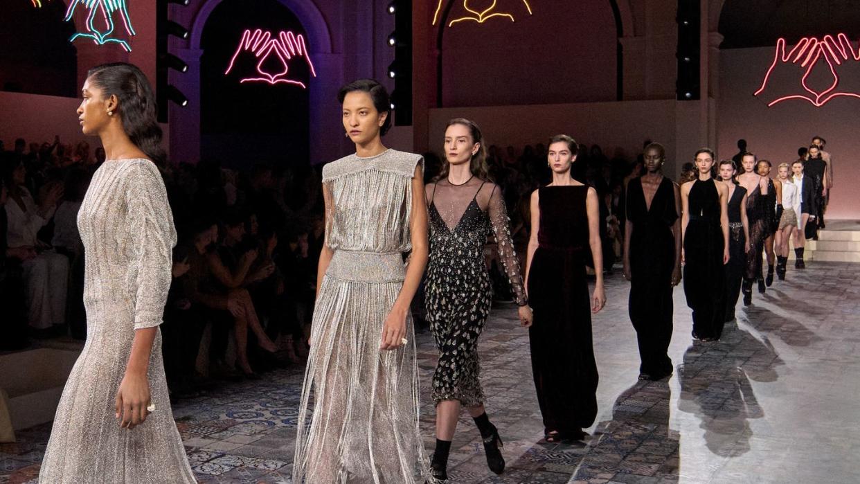 a group of women walking down a runway