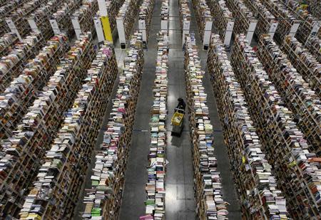 A worker gathers items for delivery from the warehouse floor at Amazon's distribution center in Phoenix, Arizona in this November 22, 2013, file photo. REUTERS/Ralph D. Freso/Files