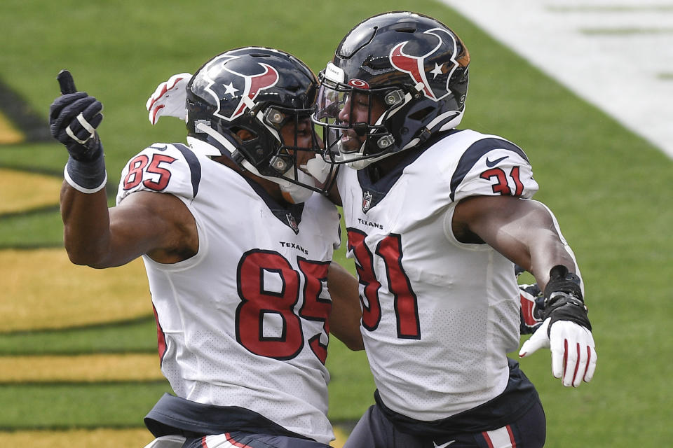 Houston Texans running back David Johnson (31) celebrates with Pharaoh Brown (85) after scoring a touchdown against the Pittsburgh Steelers during the first half of an NFL football game, Sunday, Sept. 27, 2020, in Pittsburgh. (AP Photo/Don Wright)