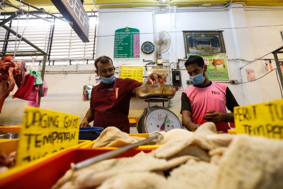 Butcher Abdul Rahman Kachi Mydin prepares the day's orders at the Taman Tun Sardon Wet Market in Penang March 26, 2020. — Sayuti Zainudin