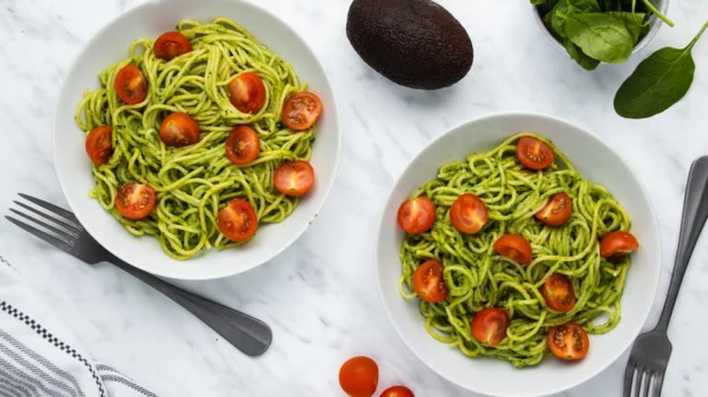 avocado tomato pasta in bowls