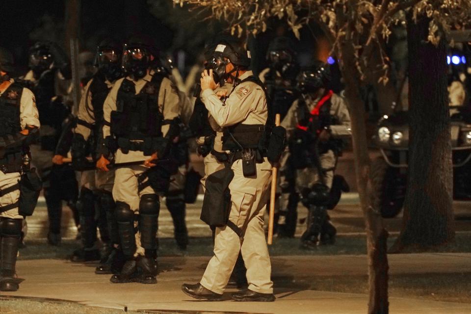 Riot police surround the Arizona Capitol after protesters reached the front of the Arizona Sentate building following the Supreme Court's decision to overturn Roe v. Wade Friday, June 24, 2022, in Phoenix. (AP Photo/Ross D. Franklin)