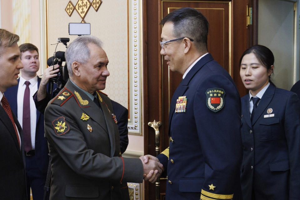 In this photo released by the Russian Defense Ministry Press Service on Friday, April 26, 2024, Russian Defense Minister Sergei Shoigu, left, shakes hands with Minister of National Defense of the People's Republic of China Dong Jun on the sidelines of the Shanghai Cooperation Organisation (SCO) Defense Ministers' Meeting in Astana, Kazakhstan. (Russian Defense Ministry Press Service via AP)