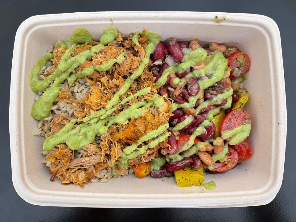 A protein plate with pork, rice, bean salad and spicy avocado dressing from Maepole restaurant on Epps Bridge Pkwy. in Athens, Ga. on Aug. 2, 2023.
