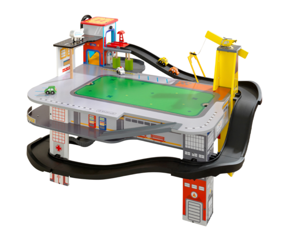 Image of a standing toy racetrack with little toy cars on the tracks.