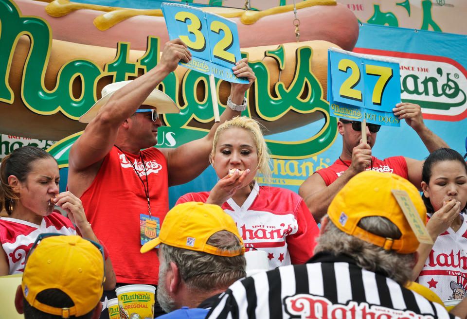 <p>Miki Sudo, center, competes in the women’s division of the Nathan’s Famous Hot Dog Eating Contest on Tuesday, July 4, 2017, in New York. The Las Vegas woman ate 41 hot dogs and buns in 10 minutes to win her fourth straight title. (AP Photo/Bebeto Matthews) </p>