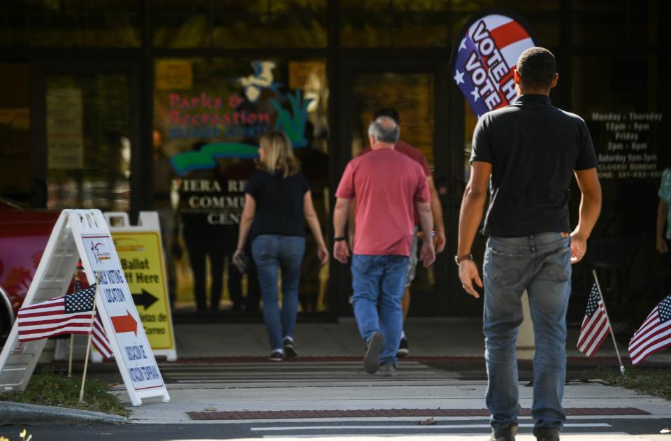 People enter and leave the early-voting location at Viera Regional Park Community Center on Friday afternoon.