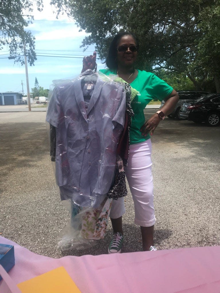 In a 2021 photo, retired school principal Ena Leiba, president of the Brevard chapter of The Links, Incorporated, holds gently used clothes donated to the first "Dress for Success" event held in partnership with the Women's Center of Brevard. The third annual event is set for 11 a.m. to 2 p.m.  Feb. 10.