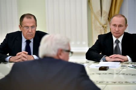 Russian President Vladimir Putin (R, back) and Foreign Minister Sergei Lavrov (L, back) attend a meeting with German Foreign Minister Frank-Walter Steinmeier at the Kremlin in Moscow, Russia, March 23, 2016. REUTERS/Kirill Kudryavtsev/Pool