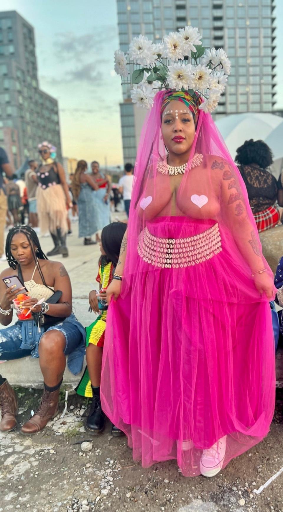 Woman in all pink see-through tulle outfit with flower headpiece at Afropunk festival