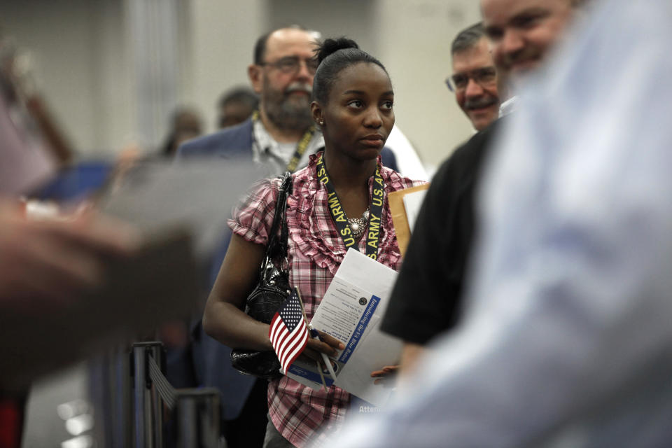 Lakeisha Bonner, of Detroit, a military veteran, stands in line at a job fair in Detroit, Tuesday, June 26, 2012. Thousands of veterans are in Detroit this week for job fair, open house, and small business conference. (AP Photo/Paul Sancya)