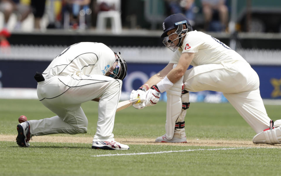 England's Joe Root hits the ball past New Zealand's Tom Latham during play on day three of the second cricket test between England and New Zealand at Seddon Park in Hamilton, New Zealand, Sunday, Dec. 1, 2019. (AP Photo/Mark Baker)