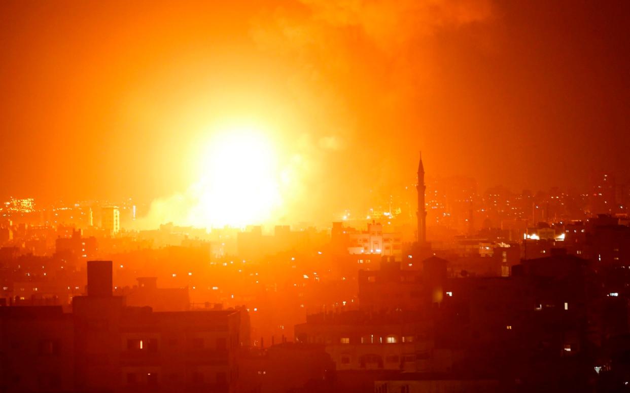 A fireball exploding during Israeli air strikes in Gaza City - AFP