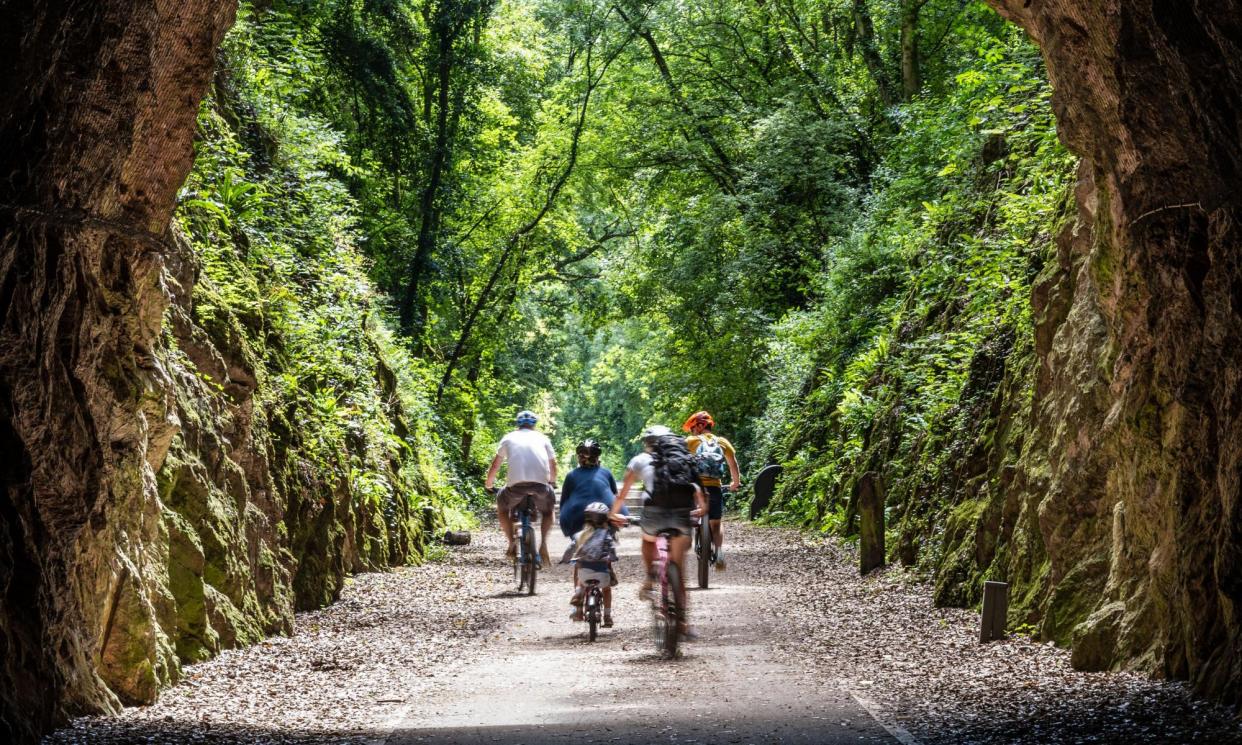 <span>A family cycles on the Strawberry Line near Axbridge in Somerset.</span><span>Photograph: Joe Dunckley/Alamy</span>