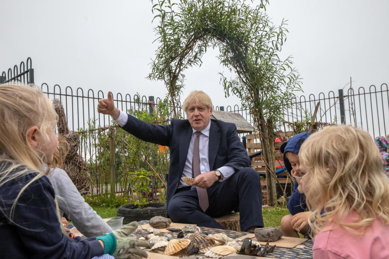 Britain's Prime Minister Boris Johnson meets children as he visits the outdoor spaces at St Issey Primary school near Wadebridge in Cornwall on June 10, 2021. (Photo by Jack Hill / POOL / AFP) (Photo by JACK HILL/POOL/AFP via Getty Images)