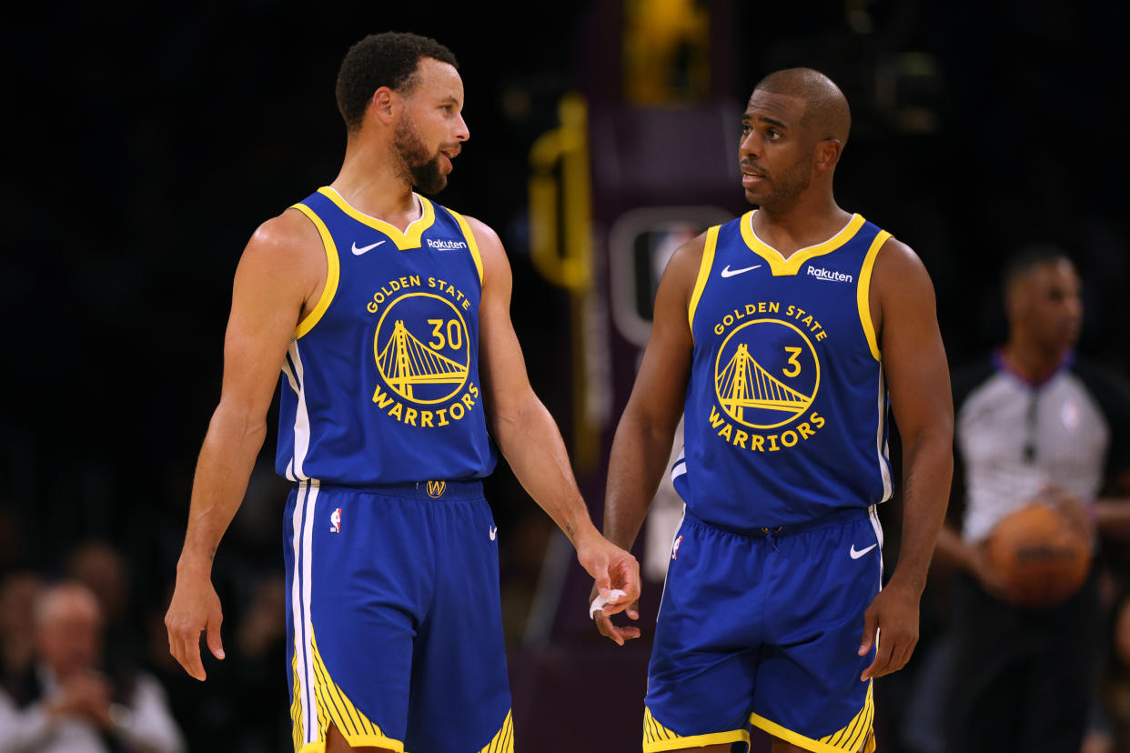 Golden State Warriors guards Stephen Curry and Chris Paul talk during a preseason game on Oct. 13, 2023. (Photo by Harry How/Getty Images)
