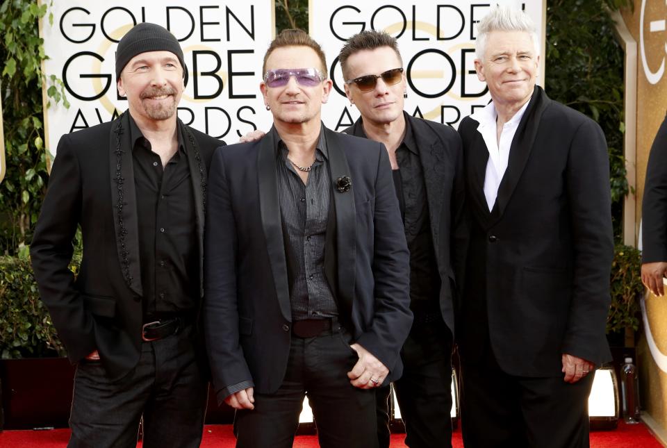 The Edge, Bono, Adam Clayton, and Larry Mullen, Jr. (L to R), from the band U2, arrive at the 71st annual Golden Globe Awards in Beverly Hills, California January 12, 2014. REUTERS/Mario Anzuoni (UNITED STATES - Tags: ENTERTAINMENT) (GOLDENGLOBES-ARRIVALS)