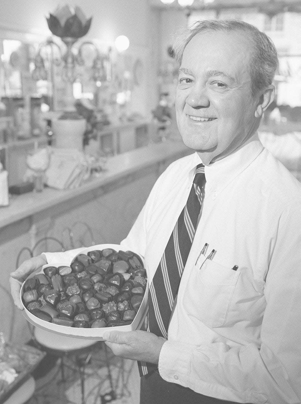 The late Jim Aglamesis of Aglamesis Bros. shows a box of hand-made chocolates in 1997.