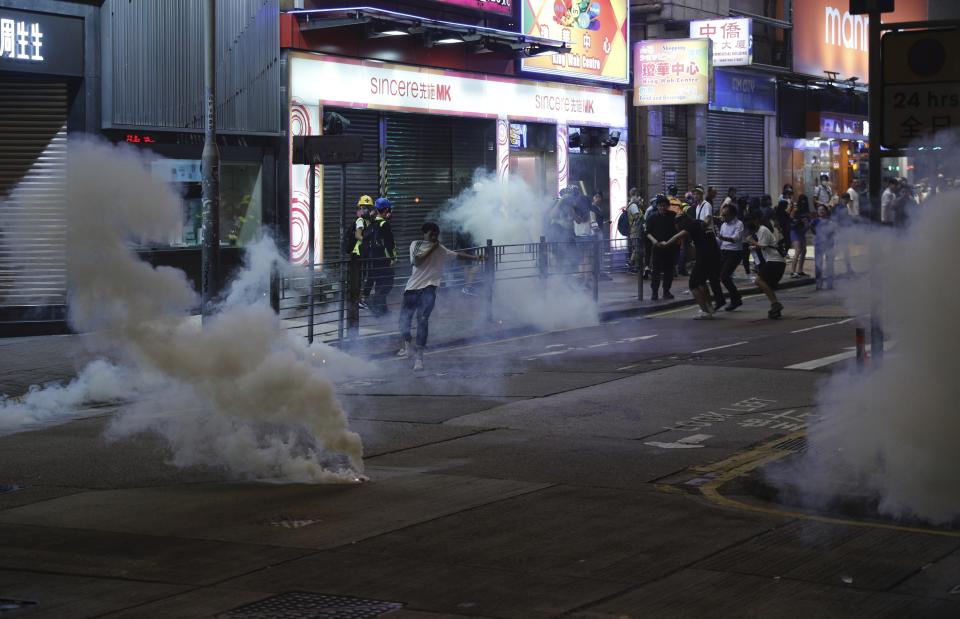 Tear gas engulf the streets of Hong Kong on Sunday, Oct. 27, 2019. Hong Kong police fired tear gas Sunday to disperse a rally called over concerns about police conduct in monthslong pro-democracy demonstrations, with protesters cursing the officers and calling them "gangster cops." (AP Photo/Kin Cheung)