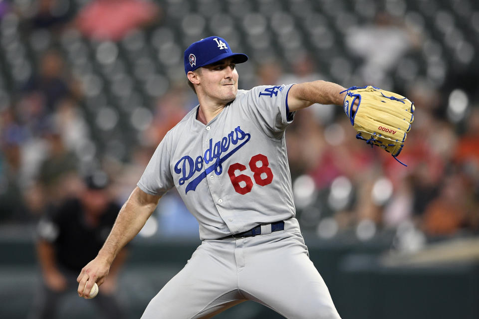 FILE - In this Wednesday, Sept. 11, 2019 file photo, Los Angeles Dodgers starting pitcher Ross Stripling delivers a pitch during a baseball game against the Baltimore Orioles in Baltimore. Stripling along with ten major leaguers won't be getting their twice-a-month paychecks during the abbreviated 60-game season. That's because the $286,500 in advance salary they received after opening day was postponed because of the coronavirus pandemic is more than what they are owed from their prorated salaries. (AP Photo/Nick Wass, File)