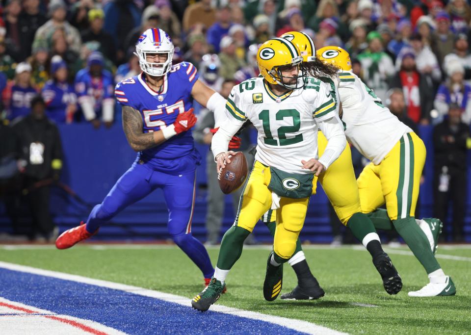 Packers Aaron Rogers escapes pressure by Bills A.J. Epenesa. 