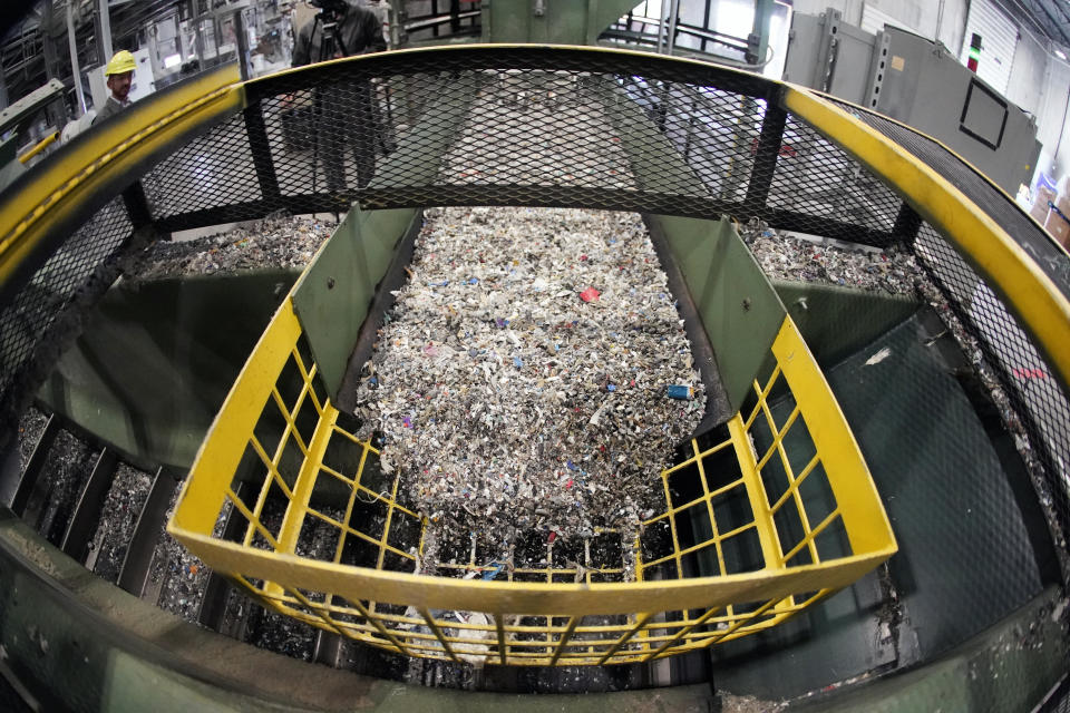 Ground up plastics that Alterra Energy receives from recycling facilities, move along a conveyor at the start of their process that transforms the material into a liquid that is then used in the manufacture of plastic, from the facility in Akron, Ohio on Thursday, Sept. 8, 2022. The U.S. facilities currently recycling plastic into new plastic are small — the largest is the 60-ton-per-day plant Alterra Energy, according to the ACC. (AP Photo/Keith Srakocic)