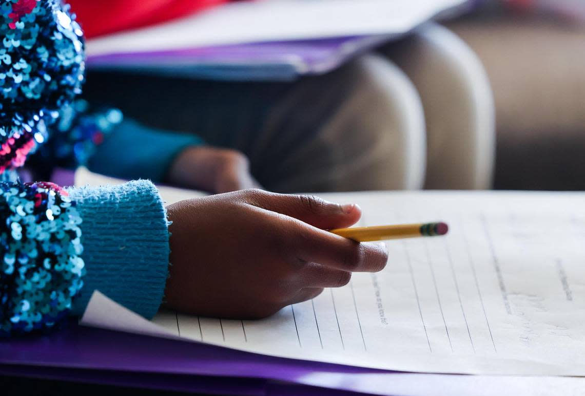 A student writes out an assignment during Latressha Leonard’s fourth-grade class on Oct. 6, 2022, at the Leadership Academy at John T. White Elementary School in Fort Worth.