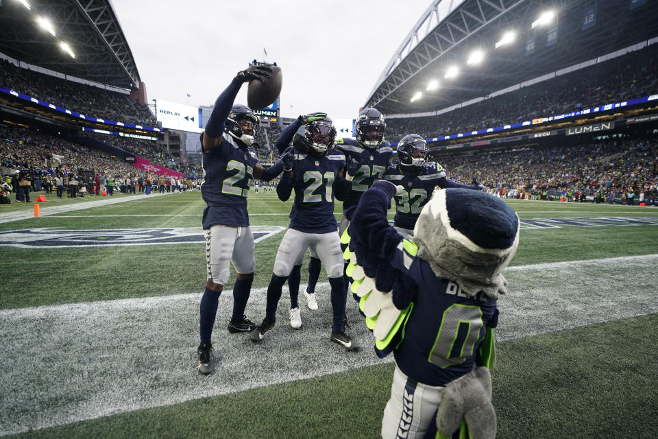 Seattle Seahawks cornerback Riq Woolen center, celebrates with teammates after a fumble recovery in the second half of an NFL football game against the Washington Commanders in Seattle, Sunday, Nov. 12, 2023. (AP Photo/Lindsey Wasson)