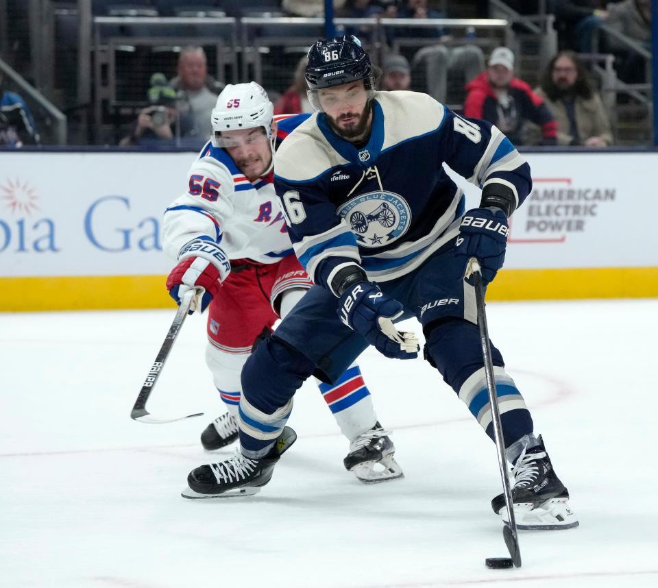 Feb. 25, 2024; Columbus, Ohio, USA; 
Columbus Blue Jackets right wing Kirill Marchenko (86) is defended by New York Rangers defenseman Ryan Lindgren (55) during the first period of an NHL game at Nationwide Arena on Sunday.