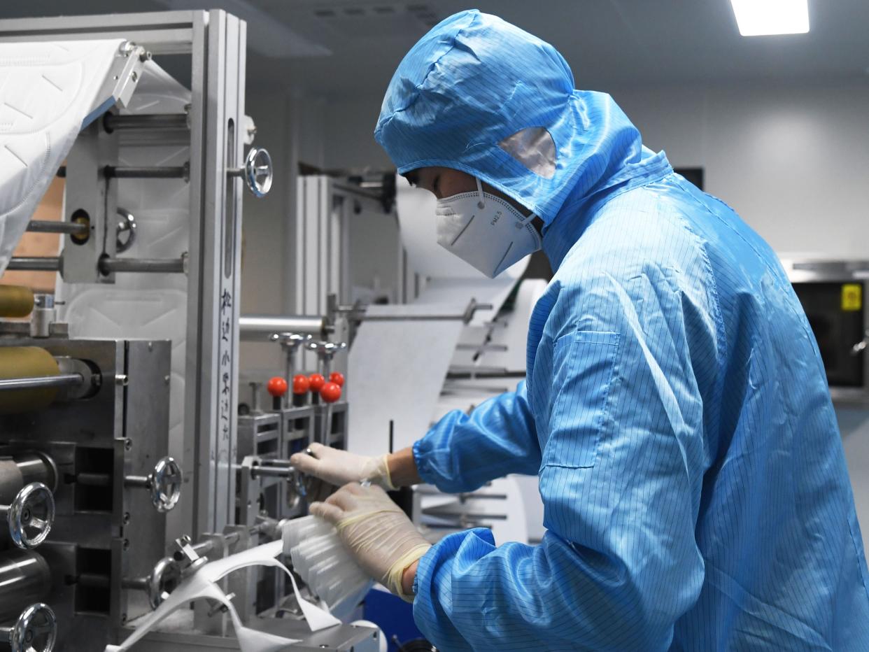 A staff works at a N95 mask production workshop of the Naton Medical Group in Beijing, capital of China, March 11, 2020. Approved by local authorities, the Naton Medical Group in Beijing has set up a facial mask production line to ensure the supply of facial masks during the fight against the novel coronavirus epidemic.