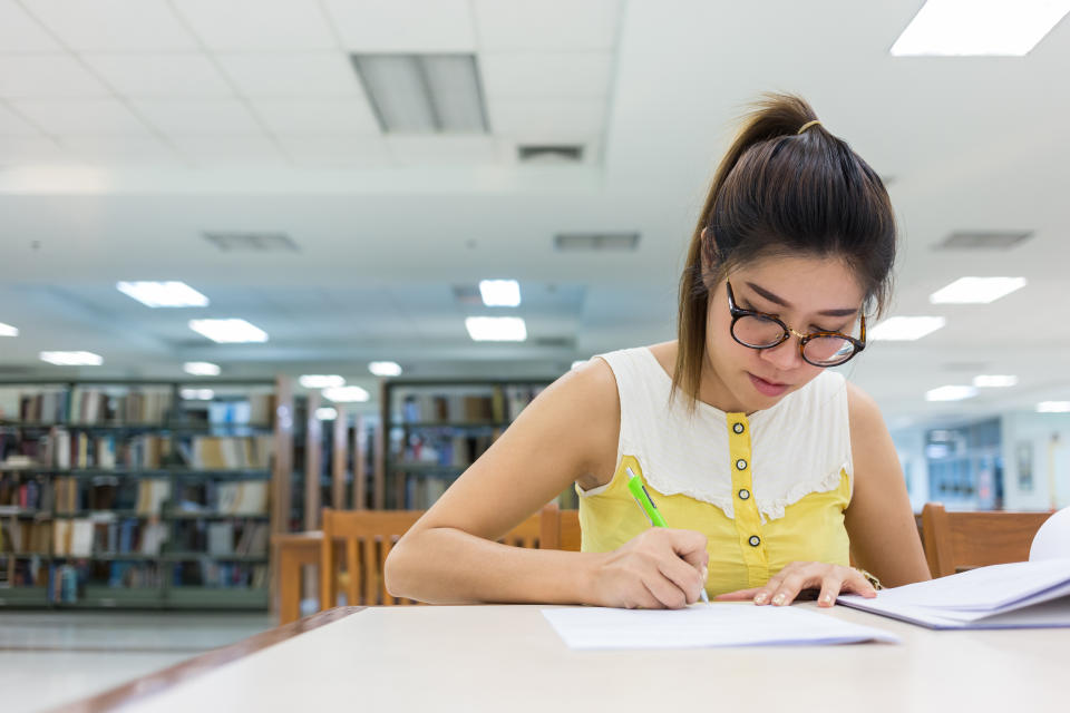 study education, woman writing on a paper, working women