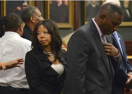 Jordan Davis' parents, Lucia McBath (C) and Ronald Davis (R) prepare to leave the courtroom for the lunch break during closing arguments in the murder trial of Michael Dunn in Jacksonville, Florida February 12, 2014. REUTERS/Bob Mack/Pool