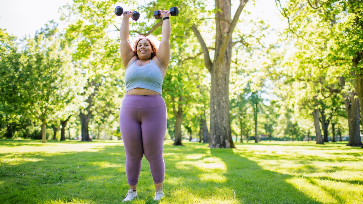  Woman doing workout with dumbbells 