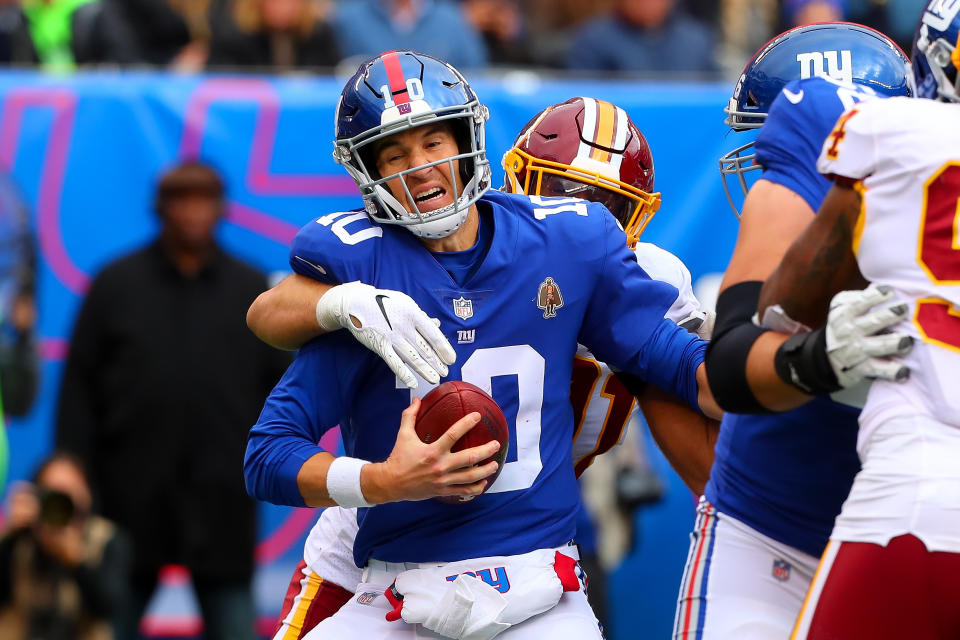 It was another rough day at the office for Eli Manning, who was sacked seven times on Sunday. (Getty Images)