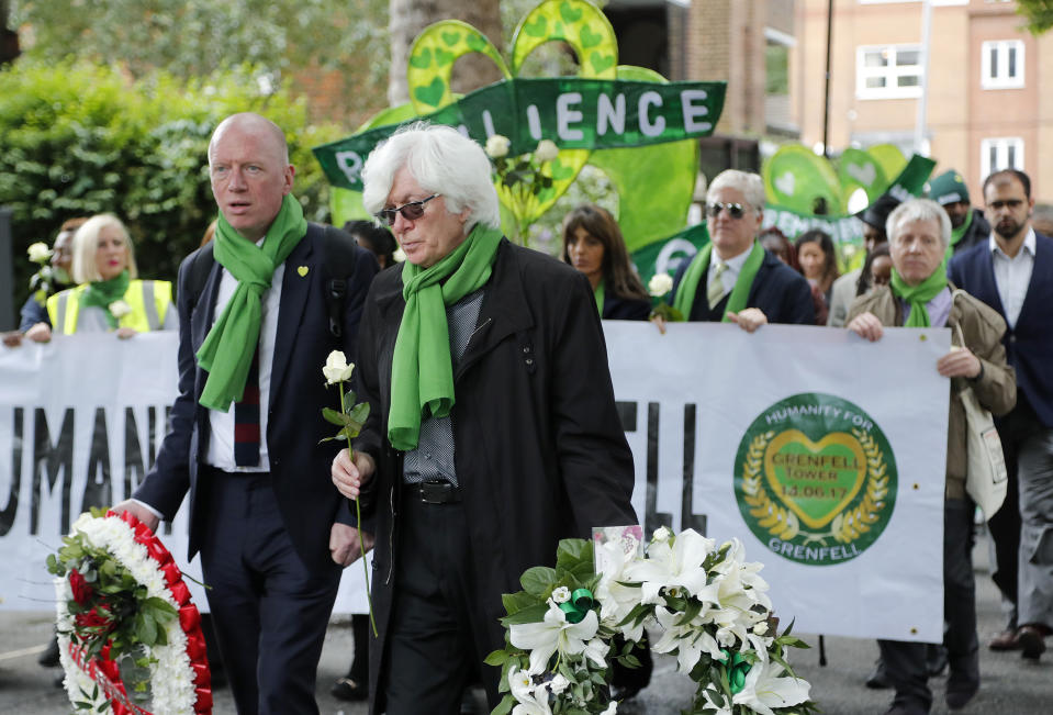 People march to mark the two-year anniversary of the Grenfell Tower block fire in London, Friday, June 14, 2019. Survivors, neighbors and politicians including London Mayor Sadiq Khan attended a church service of remembrance on Friday for the Grenfell Tower blaze, the deadliest fire on British soil since World War II. (AP Photo/Frank Augstein)