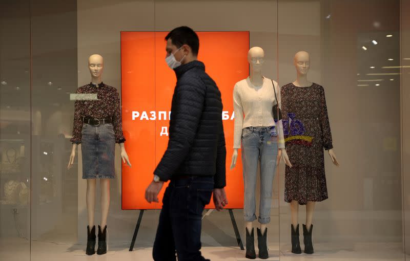 FILE PHOTO: Man wearing protective face mask walks inside Paradise shopping center in Sofia