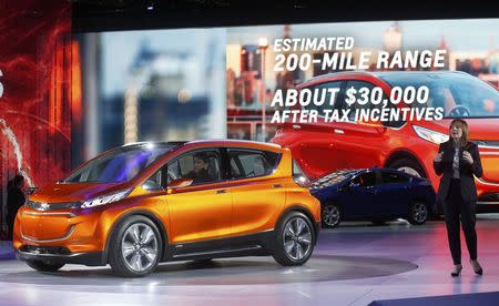 General Motors CEO Mary Barra speaks next to the Chevrolet Bolt EV electric concept car (L) and the 2016 Chevrolet Volt hybrid (rear) after they were unveiled during the first press preview day of the North American International Auto Show in Detroit, Michigan January 12, 2014. REUTERS/Rebecca Cook