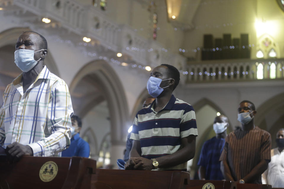 Parishioners wearing face masks to protect against coronavirus, attend a morning Christmas Mass at Holy Cross Cathedral in Lagos, Nigeria, Friday Dec. 25, 2020. Africa's top public health official says another new variant of the coronavirus appears to have emerged in Nigeria, but further investigation is needed. The discovery could add to new alarm in the pandemic after similar variants were announced in recent days in Britain and South Africa and sparked the swift return of travel restrictions. (AP Photo/Sunday Alamba)