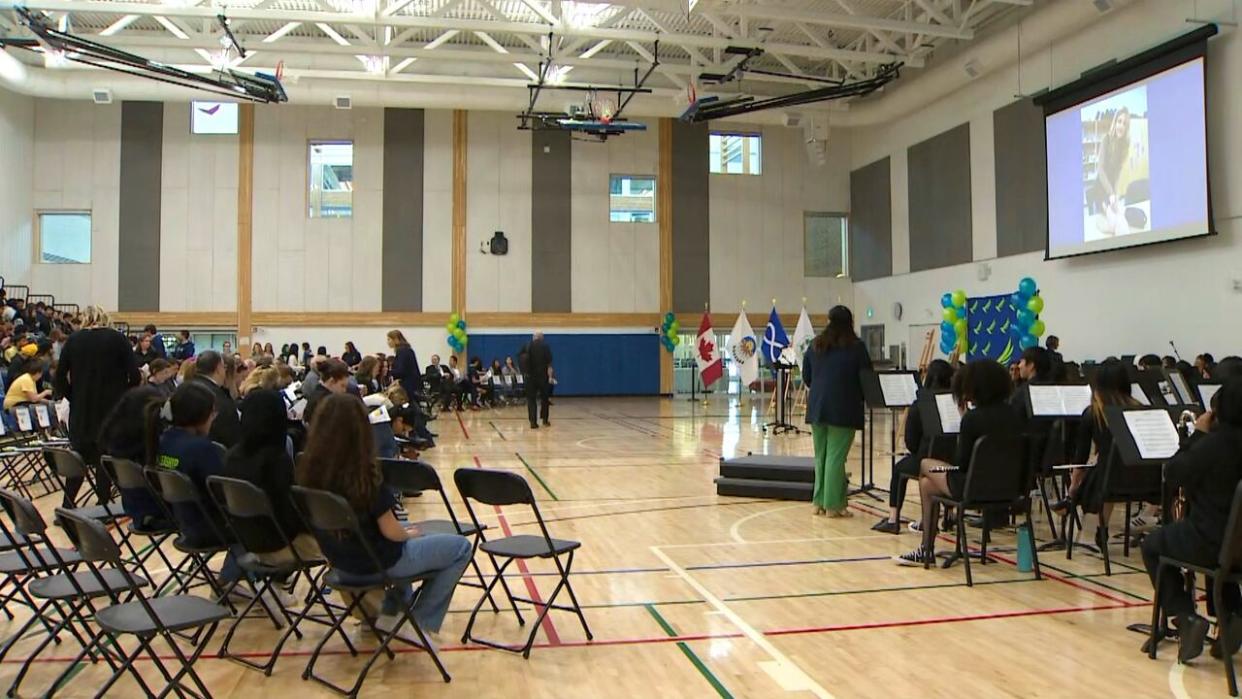 Students and Calgary Board of Education staff gathered April 26 to celebrate the first year of North Trail High School. After opening in September 2023, the school is now capping enrolment due to a higher number of registrations than expected. (Mike Symington/CBC - image credit)