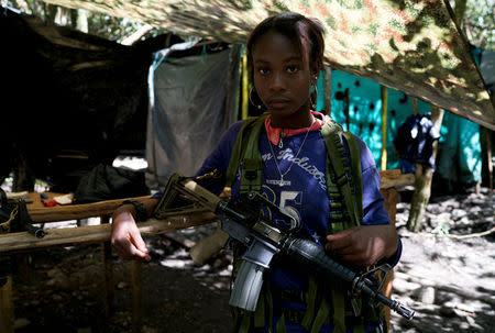 Angela, a FARC member, stands in a camp near La Elvira transitional zone in Los Robles, Colombia, January 23, 2017. REUTERS/Federico Rios