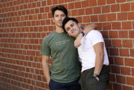 TikTok personalities Ian Paget, left, and Chris Olsen pose for a portrait in West Hollywood, Calif. on Oct. 20, 2020. Paget and Olsen, gay partners in Los Angeles, have amassed more than 4 million followers who love and encourage them as they hunker down at home, churning out goofy dance videos and playing the constant pranks that are stock-in-trade on TikTok. (AP Photo/Chris Pizzello)