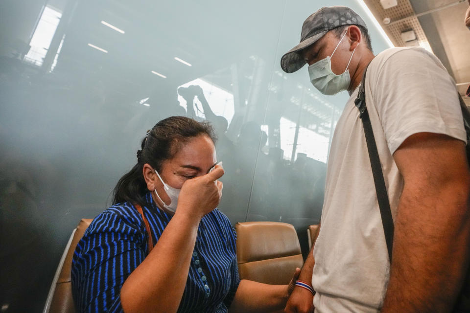 A Thai overseas worker, right, who was evacuated from Israel, meets with a relative on his arrival at Suvarnabhumi International Airport, in Samut Prakarn Province, Thailand, Thursday, Oct. 12, 2023. The first Thai nationals evacuated since the latest war between Israel and Hamas returned home Thursday. (AP Photo/Sakchai Lalit)