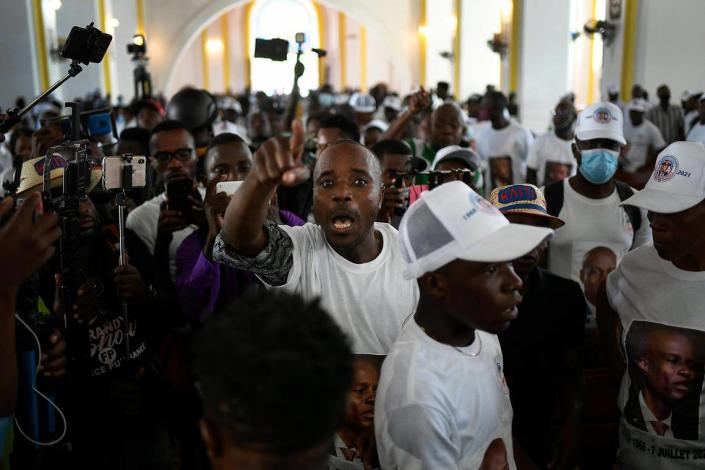 A man yells for justice during a memorial service for assassinated Haitian President Jovenel Moise in the Cathedral of Cap-Haitien, Haiti, Thursday, July 22, 2021. Moise was killed in his home in Port-au-Prince on July 7.