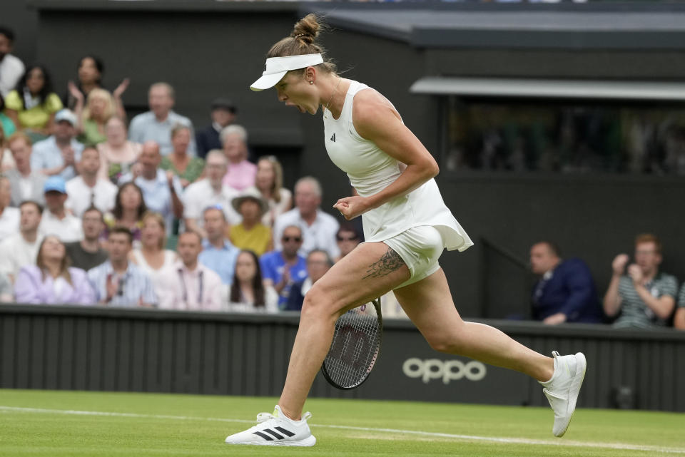 Ukraine's Elina Svitolina reacts after winning a point against Poland's Iga Swiatek in a women's singles match on day nine of the Wimbledon tennis championships in London, Tuesday, July 11, 2023. (AP Photo/Kirsty Wigglesworth)