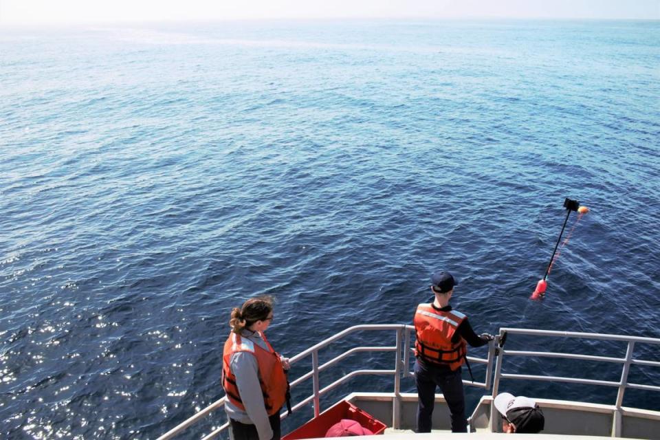 Kaitlin Palmer, left, and Anne Simonis, right, wait to retrieve their drifting buoy with a sound recorder attached on March 12, 2023. The sound recorder was deployed in the Pacific Ocean near the Morro Bay offshore wind energy area for about 30 minutes.