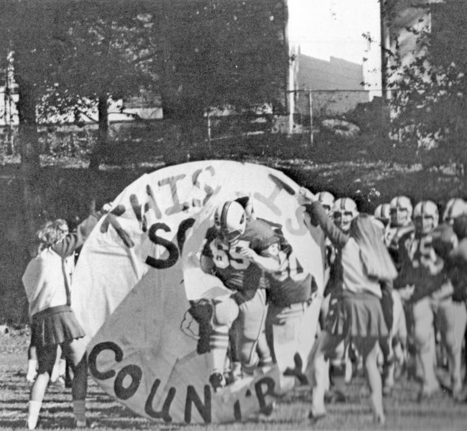 Co-captain David Brinker leads the Fighting Scots onto the field prior to their 1972 Homecoming victory against Carleton.