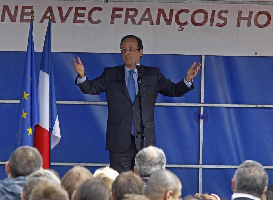 Socialist presidential candidate Francois Hollande waves to supporters after delivering his speech outside a factory he visited in Hirson, eastern France, as part of the campaign for the second round of the French presidential elections, Tuesday April 24, 2012.(AP Photo/Remy de la Mauviniere)